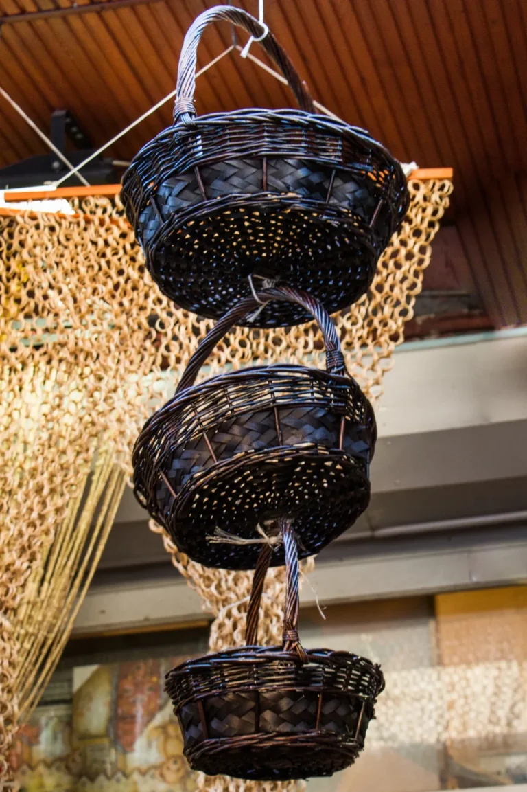 low-angle-view-lighting-equipment-hanging-against-wall-building